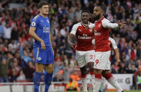 Arsenal's Alexandre Lacazette, right celebrates after scoring the opening goal of the game during their English Premier League soccer match between Arsenal and Leicester City at the Emirates stadium in London, Friday, Aug. 11, 2017. (AP Photo/Alastair Grant)