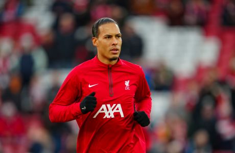 Liverpool's Virgil van Dijk runs during the warm up prior to the start of the English FA Cup fourth round soccer match between Liverpool and Norwich, at Anfield stadium in Liverpool, England, Sunday, Jan. 28, 2024. (AP Photo/Jon Super)