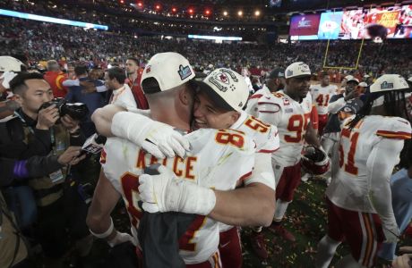 Kansas City Chiefs tight end Travis Kelce, (87) and defensive end George Karlaftis (56) hug after winning the NFL Super Bowl 57 football game, Sunday, Feb. 12, 2023, in Glendale, Ariz. (AP Photo/Doug Benc)