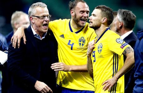 Sweden coach Janne Andersson celebrates with Andreas Granqvist and Marcus Berg, right, at the end of the World Cup qualifying play-off second leg soccer match between Italy and Sweden, at the Milan San Siro stadium, Italy, Monday, Nov. 13, 2017. Four-time champion Italy has failed to qualify for World Cup; Sweden advances with 1-0 aggregate win in playoff. (AP Photo/Antonio Calanni)