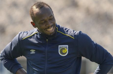 Jamaica's Usain Bolt reacts during training with the Central Coast Mariners soccer team in Newcastle, Australia, Tuesday, Aug. 21, 2018. Bolt's attempt to win a contract to play as a professional in Australian football's A-League began in earnest on his 32nd birthday Tuesday. (AP Photo/Steve Christo)