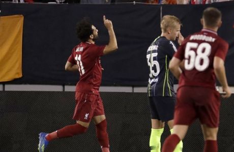 Fans react as Liverpool midfielder Mohamed Salah, center bottom, celebrates after scoring a goal on Manchester City during the second half of an International Champions Cup tournament soccer match, Wednesday, July 25, 2018, in East Rutherford, N.J. Liverpool won 2-1. (AP Photo/Julio Cortez)