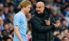 Manchester City's head coach Pep Guardiola, right, gives instructions to Manchester City's Kevin De Bruyne during the English FA Cup third round soccer match between Manchester City and Huddersfield Town, at the Etihad stadium in Manchester, England, Sunday, Jan. 7, 2024. (AP Photo/Dave Thompson)