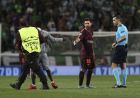 A fan who ran onto the pitch is taken away by a steward near Barcelona's Lionel Messi, during a Champions League, Group D soccer match between Sporting CP and FC Barcelona at the Alvalade stadium in Lisbon, Wednesday Sept. 27, 2017. (AP Photo/Armando Franca)