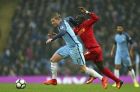 Manchester City's Kevin De Bruyne, left, runs with the ball away from Liverpool's Sadio Mane during the English Premier League soccer match between Manchester City and Liverpool at the Etihad Stadium in Manchester, England, Sunday March 19, 2017. (AP Photo/Dave Thompson)