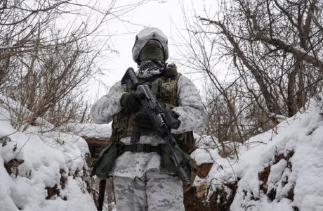 epa09708941 Ukrainian serviceman checks the situation at the positions on a front line near the Avdiivka village, not far from pro-Russian militants controlled city of Donetsk, Ukraine, 25 January 2022. US and Britain announced it is withdrawing some diplomats, nonessential personnel, and family members from their embassies in Kiev amid growing fears of a Russian invasion. Russia has recently strengthened its groups near the border with Ukraine and Belarus, with no signs of de-escalation, Pentagon spokesman John Kirby said on 24 January.  EPA/STANISLAV KOZLIUK