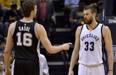 San Antonio Spurs center Pau Gasol (16) and his brother, Memphis Grizzlies center Marc Gasol (33), stand on the court between plays during the first half of Game 6 in an NBA basketball first-round playoff series Thursday, April 27, 2017, in Memphis, Tenn. (AP Photo/Brandon Dill)