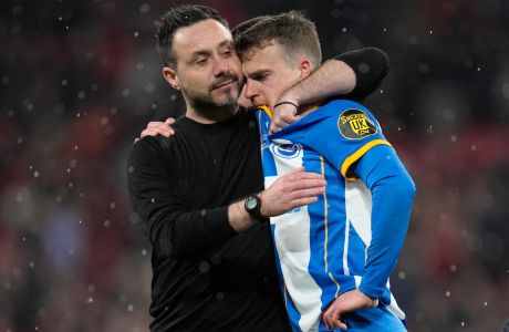 Brighton's head coach Roberto De Zerbi comforts Brighton's Solly March after the English FA Cup semifinal soccer match between Brighton and Hove Albion and Manchester United at Wembley Stadium in London, Sunday, April 23, 2023. (AP Photo/Kirsty Wigglesworth)