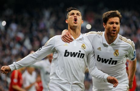 Real Madrid's Cristiano Ronaldo from Portugal, left, celebrates with teammate Xabi Alonso after scoring during a semifinal second leg Champions League soccer match against Bayern Munich at the Santiago Bernabeu stadium, in Madrid, Wednesday, April 25, 2012. (AP Photo/Daniel Ochoa de Olza)