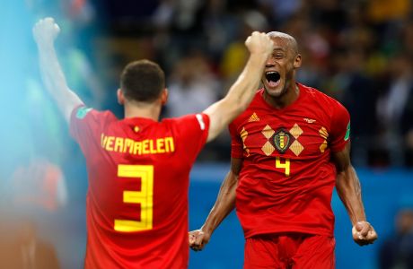 Belgium's Thomas Vermaelen, left, and Vincent Kompany celebrate after winning the quarterfinal match between Brazil and Belgium at the 2018 soccer World Cup in the Kazan Arena, in Kazan, Russia, Friday, July 6, 2018. (AP Photo/Francisco Seco)