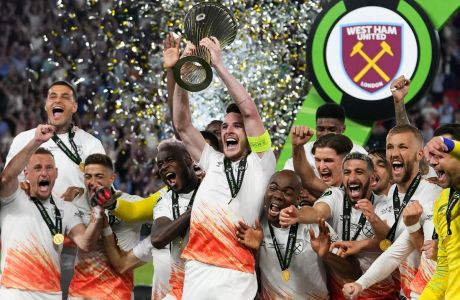 West Ham's Declan Rice lifts the trophy after winning the Europa Conference League final soccer match between Fiorentina and West Ham at the Eden Arena in Prague, Wednesday, June 7, 2023. West Ham won 2-1. (AP Photo/Petr David Josek)