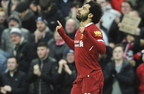 Liverpool's Mohamed Salah celebrates after scoring his side's first goal during the English Premier League soccer match between Liverpool and Tottenham Hotspur at Anfield in Liverpool, England, Sunday, Feb. 4, 2018. (AP Photo/Rui Vieira)