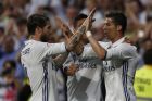 Real Madrid's Cristiano Ronaldo, right, celebrates with teammate Sergio Ramos, left, after scoring their side's third goal against Sevilla during the La Liga soccer match between Real Madrid and Sevilla at the Santiago Bernabeu stadium in Madrid, Sunday, May 14, 2017. (AP Photo/Francisco Seco)