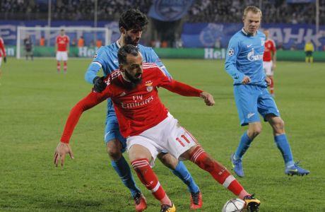 Benficas Kostas Mitroglou, front, challenge for the ball with Zenit's Luis Neto, behind, during their Champions League League Round of 16 second leg soccer match between Zenit and Benfica at Petrovsky stadium in St.Petersburg, Russia, Wednesday, March 9, 2016. (AP Photo/Dmitri Lovetsky)