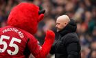 Manchester United's head coach Erik ten Hag walks past the mascot before an English Premier League soccer match between Manchester United and Everton at the Old Trafford stadium in Manchester, England, Saturday, March 9, 2024. (AP Photo/Dave Thompson)