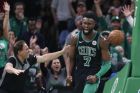 Boston Celtics' Jaylen Brown (7) reacts after dunking during the second half of an NBA basketball game against the Houston Rockets in Boston, Sunday, March 3, 2019. (AP Photo/Michael Dwyer)