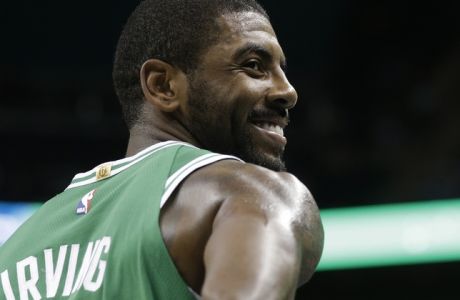 Boston Celtics' Kyrie Irving (11) smiles in the first half of a preseason NBA basketball game against the Charlotte Hornets in Charlotte, N.C., Wednesday, Oct. 11, 2017. (AP Photo/Chuck Burton)