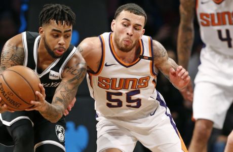 Brooklyn Nets guard D'Angelo Russell (1) scoops the ball away from Phoenix Suns guard Mike James (55) as Suns center Tyson Chandler (4) watches in the second half of an NBA basketball game, Tuesday, Oct. 31, 2017, in New York. The Suns defeated the Nets 122-114. (AP Photo/Kathy Willens)