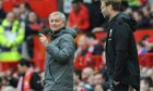Manchester United coach Jose Mourinho, left, and Liverpool coach Juergen Klopp react on the sidelines during the English Premier League soccer match between Manchester United and Liverpool at Old Trafford in Manchester, England, Saturday, March 10, 2018. (AP Photo/Rui Vieira)