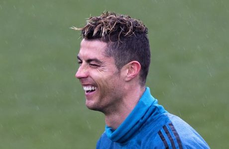 Real Madrid's Cristiano Ronaldo laughs during a training session in Madrid, Tuesday, April 10, 2018. Real Madrid will play Juventus Wednesday in a Champions League quarter-final, 2nd leg soccer match.(AP Photo/Paul White