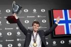 Magnus Carlsen, of Norway, smiles as he holds up his championship trophy during the award ceremony for the World Chess Championship, Wednesday, Nov. 30, 2016, in New York. Reigning champ Carlsen defeated Sergey Karjakin, of Russia. (AP Photo/Mary Altaffer)