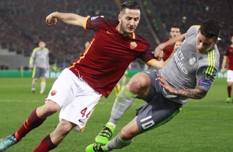 Real Madrid's James Rodriguez, right, vies for the ball with Roma's Kostantinos Manolas during a Champions League, round of 16, first-leg soccer match between Roma and Real Madrid, at the Rome Olympic stadium, Wednesday, Feb. 17, 2016. (AP Photo/Andrew Medichini)