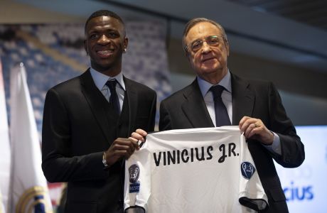 Brazilian soccer player Vinicius Jr, left, and Real Madrid President Florentino Perez pose for the media during his official presentation for Real Madrid at the Santiago Bernabeu stadium in Madrid, Spain, Friday, July 20, 2018. (AP Photo/Francisco Seco)