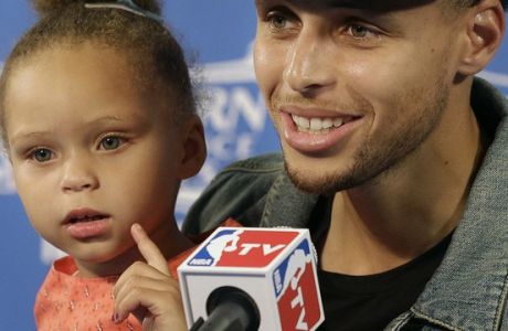 Golden State Warriors guard Stephen Curry speaks with his daughter Riley at a news conference after Game 5 of the NBA basketball Western Conference finals against the Houston Rockets in Oakland, Calif., Wednesday, May 27, 2015. The Warriors won 104-90 and advanced to the NBA Finals. (AP Photo/Ben Margot)