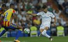 Real Madrid's Marco Asensio, right, scores the opening goal past Valencia's Ruben Vezo during a Spanish La Liga soccer match between Real Madrid and Valencia at the Santiago Bernabeu stadium in Madrid, Sunday, Aug. 27, 2017. (AP Photo/Francisco Seco)