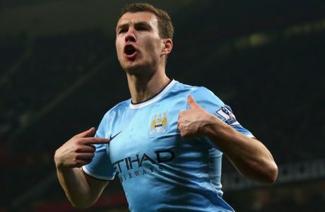 MANCHESTER, ENGLAND - MARCH 25:  Edin Dzeko of Manchester City celebrates scoring the second goal during the Barclays Premier League match between Manchester United and Manchester City at Old Trafford on March 25, 2014 in Manchester, England.  (Photo by Alex Livesey/Getty Images)