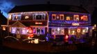 In this photo taken with a fisheye lens, houses decorated with festive lights are seen in South Shields, England, Friday, Dec. 16, 2011. (AP Photo/Scott Heppell)