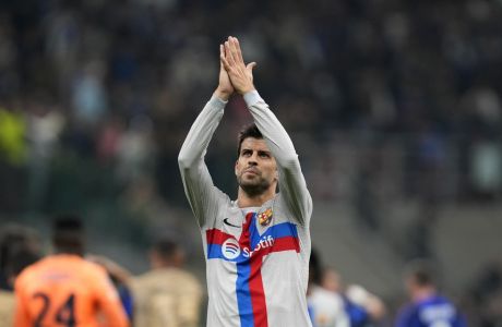 Barcelona's Gerard Pique applauds to supporters at the end of the Champions League group C soccer match between Inter Milan and Barcelona at the San Siro stadium in Milan, Italy, Tuesday, Oct. 4, 2022. (AP Photo/Antonio Calanni)