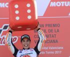 Moto GP World Champion winner Marc Marquez of Spain celebrates on the podium after finishing third at the Valencia Motorcycle Grand Prix, the last race of the season, at the Ricardo Tormo circuit in Cheste near Valencia, Spain, Sunday Nov. 12, 2017. Marquez won his fourth MotoGP world title on Sunday after challenger Andrea Dovizioso crashed during the season-concluding Valencia Grand Prix. (AP Photo/Alberto Saiz)