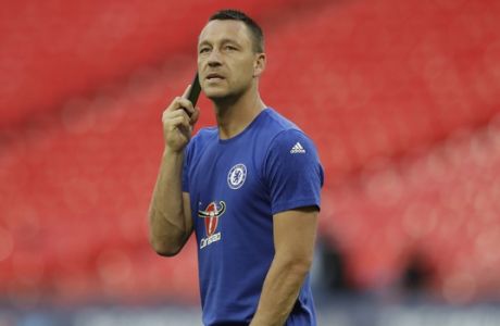 Chelsea's John Terry speaks on the phone walking alone on the pitch after his team lost the English FA Cup final soccer match between Arsenal and Chelsea at the Wembley stadium in London, Saturday, May 27, 2017. (AP Photo/Matt Dunham)