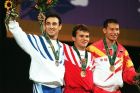 Silver medalist Valerios Leonidis of Greece, gold medalis Turkey's Naim Suleymanoglu and bronze medalist China's Xiao Jiangang wave during the Olympic medal ceremony at the Georgia World Congress Center in Atlanta Monday, July 22, 1996. Gold medalist Naim Suleymanoglu is the first person ever to win three Olympic gold medals in weightlifting.  (AP Photo/Michael Probst)