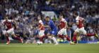 Chelsea's Eden Hazard, center, runs with the ball during the English Premier League soccer match between Chelsea and Arsenal at Stamford bridge stadium in London, Saturday, Aug. 18, 2018. (AP Photo/Tim Ireland)