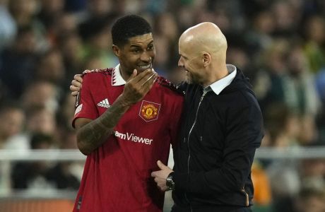 Manchester United's Marcus Rashford speaks to Manchester United's head coach Erik ten Hag after being substituted during the Europa League round of 16 second leg soccer match between Real Betis and Manchester United at the Benito Villamarin stadium in Seville, Spain, Thursday, March 16, 2023. (AP Photo/Jose Breton)