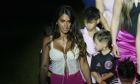 Antonela Roccuzzo, left, wife of Lionel Messi, walks with the couples children during an event to present Messi to fans one day after Inter Miami MLS soccer team finalized his signing through the 2025 season, Sunday, July 16, 2023, in Fort Lauderdale, Fla. (AP Photo/Rebecca Blackwell)