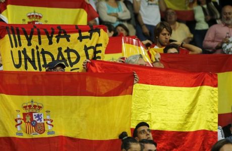Real Madrid fans display Spanish national flags in support of a united Spain against the Catalonian referendum for independence, during a Spanish La Liga soccer match between Real Madrid and Espanyol at the Santiago Bernabeu stadium in Madrid, Spain, Sunday, Oct. 1, 2017. (AP Photo/Paul White)