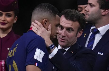 France's Kylian Mbappe is consoled by French President Emmanuel Macron after the World Cup final soccer match between Argentina and France at the Lusail Stadium in Lusail, Qatar, Sunday, Dec.18, 2022. (AP Photo/Manu Fernandez)