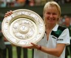 Jana Novotna, of the Czech Republic, displays the women's singles trophy after her victory over France's Nathalie Tauziat in the final on Wimbledon's Centre Court, Saturday, July 4, 1998. Novotna won the match 6-4, 7-6 (7-2). (AP Photo/Dave Caulkin )