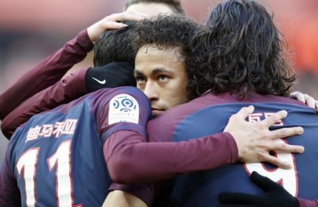 PSG's Neymar hugs teammates after Angel Di Maria scores a goal against Strasbourg during the French League One soccer match between Paris Saint Germain and Strasbourg, at the Parc des Princes stadium in Paris, France, Saturday, Feb. 17, 2018. (AP Photo/Francois Mori)