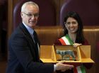 Coach Claudio Ranieri, left, receives an honorary award for his work at Leicester City from Rome's Mayor Virginia Raggi, at Rome's Capitol Hill, Thursday, March 30, 2017. (AP Photo/Andrew Medichini)