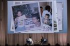 Family photos are displayed on a giant screen as former first lady Michelle Obama, left, is interviewed by Elizabeth Alexander during the "Becoming: An Intimate Conversation with Michelle Obama" at Barclays Center in Saturday, Dec. 1, 2018, in New York. (AP Photo/Mary Altaffer)
