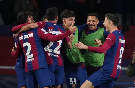 Barcelona's Robert Lewandowski, right, celebrates with his teammates after scoring his side's third goal during the Champions League, round of 16, second leg soccer match between Barcelona and SSC Napoli at the Olympic Lluis Companys stadium in Barcelona, Spain, Tuesday, March 12, 2024. (AP Photo/Emilio Morenatti)
