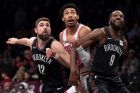 Chicago Bulls forward Otto Porter Jr.,, center, jostles for position against Brooklyn Nets forward Joe Harris (12) and forward DeMarre Carroll (9) during a free throw in the second half of an NBA basketball game, Friday, Feb. 8, 2019, in New York. The Bulls won 125-106. (AP Photo/Mary Altaffer)