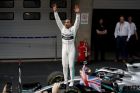 Mercedes driver Lewis Hamilton of Britain standing on his car celebrates after winning the Chinese Formula One Grand Prix at the Shanghai International Circuit in Shanghai on Sunday, April 14, 2019. (AP Photo/Andy Wong)