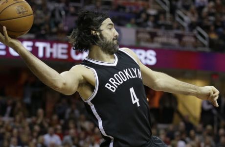 Brooklyn Nets' Luis Scola, from Argentina, looks to pass in the first half of an NBA basketball game against the Cleveland Cavaliers, Friday, Jan. 27, 2017, in Cleveland. (AP Photo/Tony Dejak)