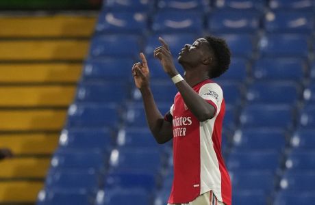 Arsenal's Bukayo Saka celebrates after scoring his sides 4th goal of the game during the English Premier League soccer match between Chelsea and Arsenal at Stamford Bridge in London, Wednesday, April 20, 2022. Arsenal won the match 4-2. (AP Photo/Frank Augstein)