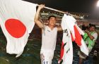 Japan's Kazuyoshi Miura holds his national flag as he parades around the stadium after they defeated Iran 3-2 (1-0) in overtime following their World Cup qualifying match in Johor Bahru, Malaysia Sunday, November 16, 1997. (AP Photo/Mark Fallander)
